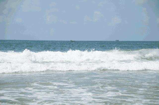 女子海边散步,女子在海边拍照被海浪吹走